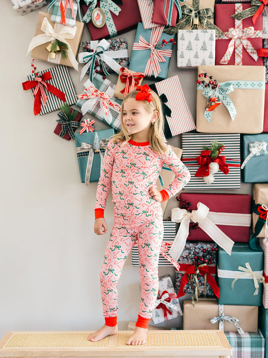 A girl wearing the pink bamboo candy cane pajamas