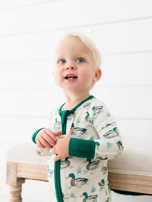a toddler boy wearing dock pond bamboo romper pjs perfect for fall