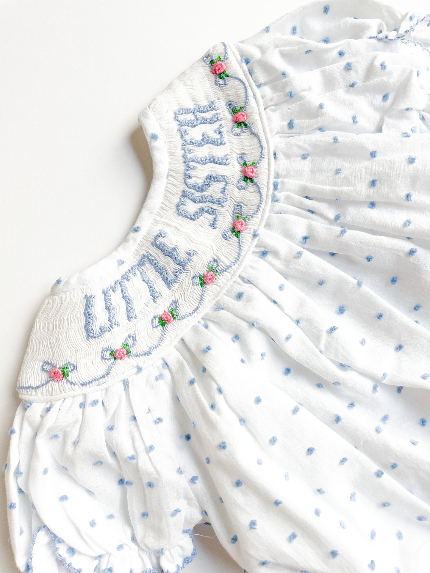 Little sister bubble smocked with pink flowers and blue dots