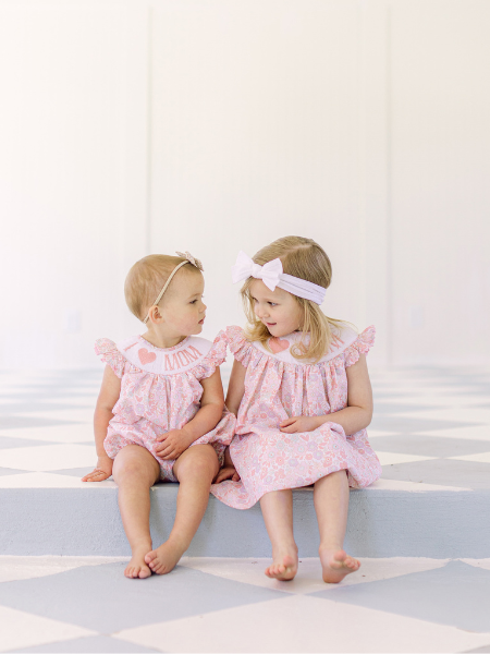 Little girls in smocked bubble and dress for Mother's Day.