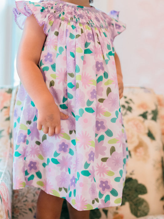 Child wearing a floral dress with a soft focus background