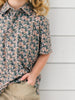 a little boy wearing a camo duck themed polo for duck days, fall and hunting