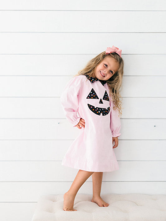 a young girl wearing the pink Jack-O-Lantern Dress 