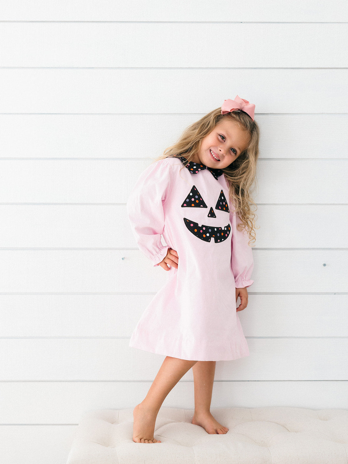 a young girl wearing the pink Jack-O-Lantern Dress 
