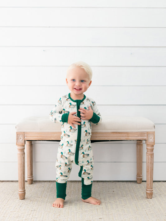 a toddler boy wearing dock pond bamboo romper pjs perfect for fall