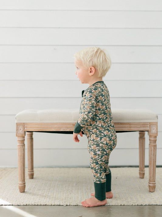 A baby wearing the perfect bamboo romper for duck days, fall and hunting