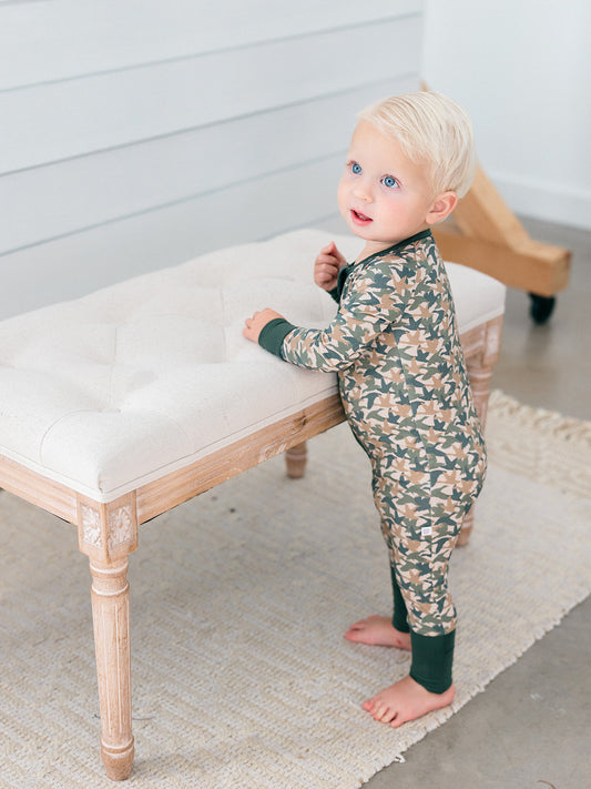 A baby wearing the perfect bamboo romper for duck days, fall and hunting