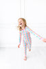 Child wearing a colorful gift pajama on a white background