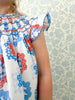 close up details of a red white and blue hand smocked dress