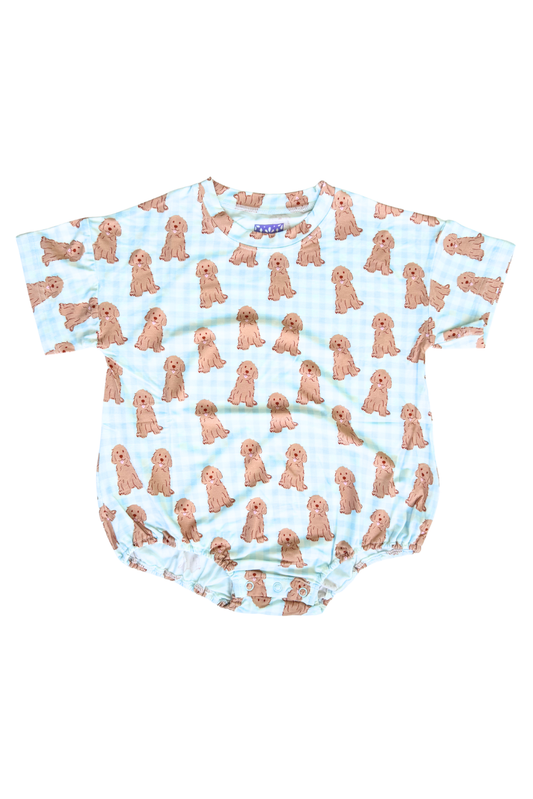Baby romper with dog pattern on a light blue background