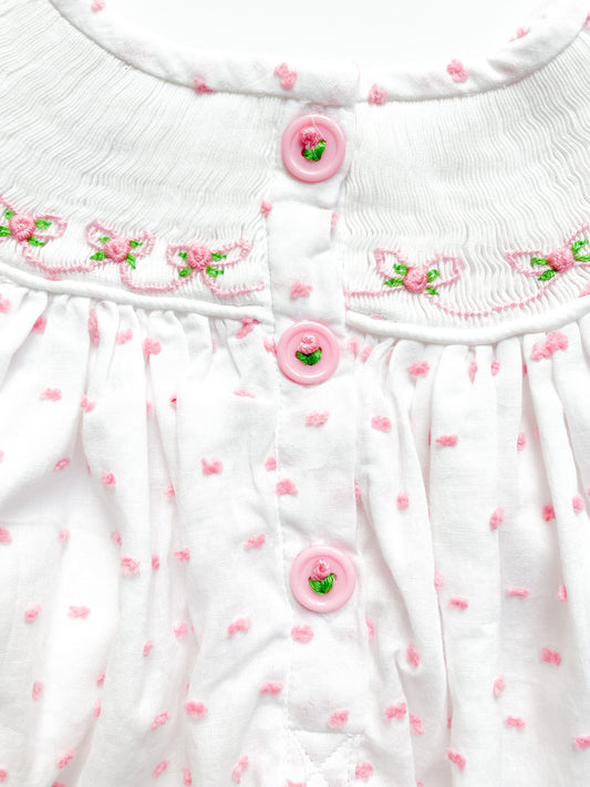 Pink buttons on back of big sister dress, adorned with pink flowers